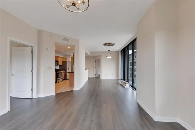 a view of a room with wooden floor and a window