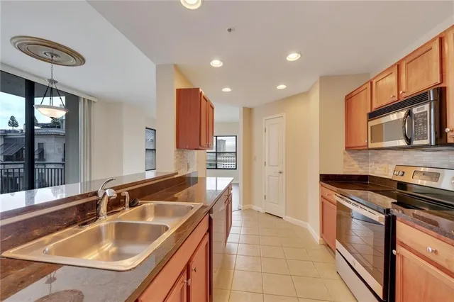 a kitchen with a sink and a refrigerator