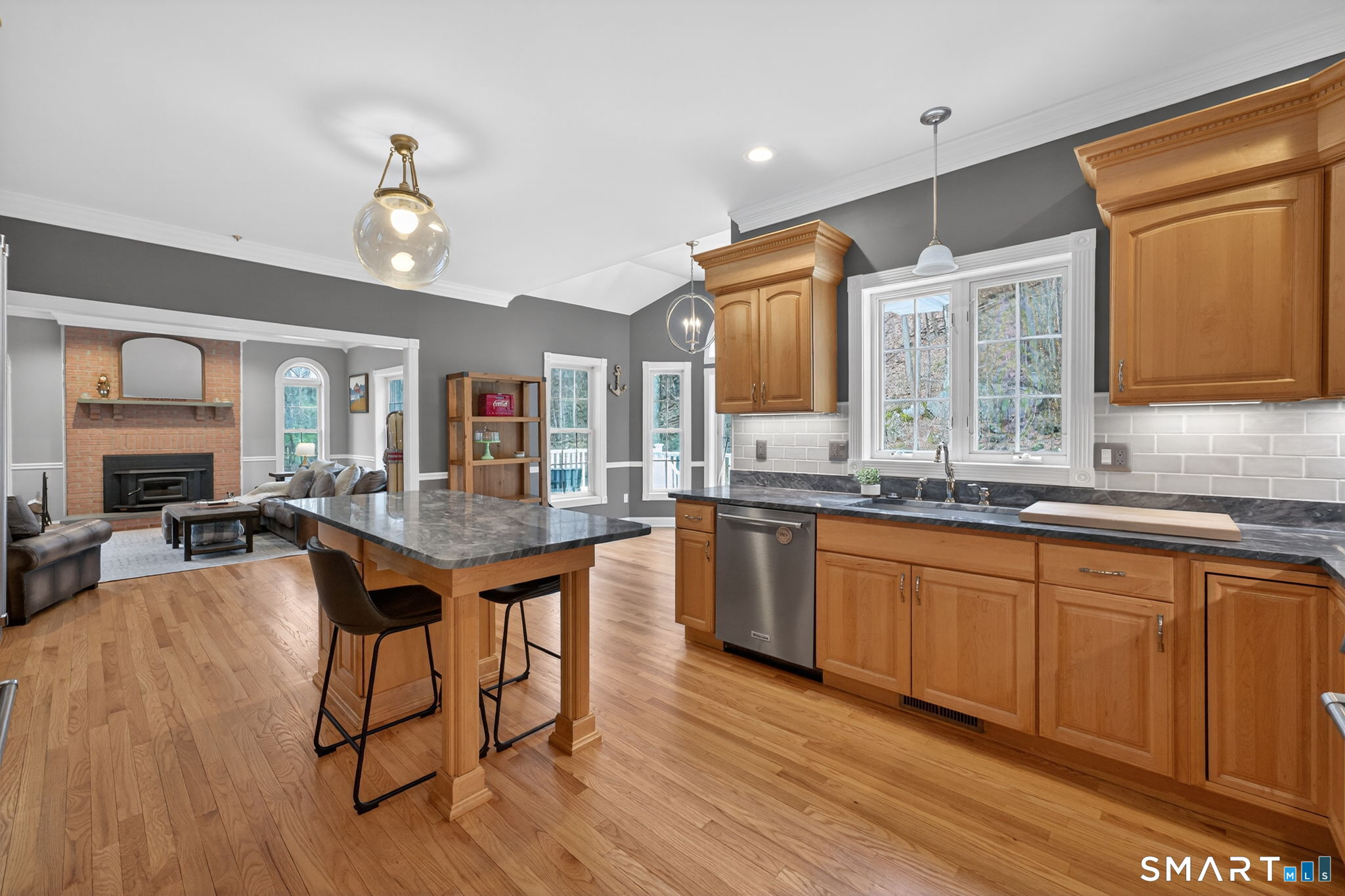 29 Boulder Ridge Southington, CT 06489 - Photo 14 of 40 a kitchen with granite countertop a table chairs stove a sink dishwasher and cabinets