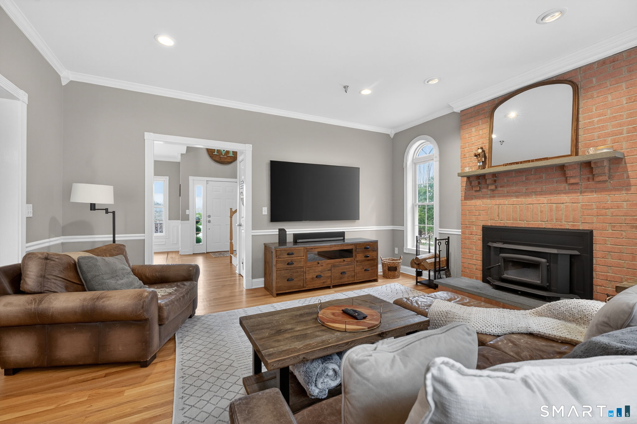 29 Boulder Ridge Southington, CT 06489 - Photo 16 of 40 a living room with furniture a flat screen tv and a fireplace