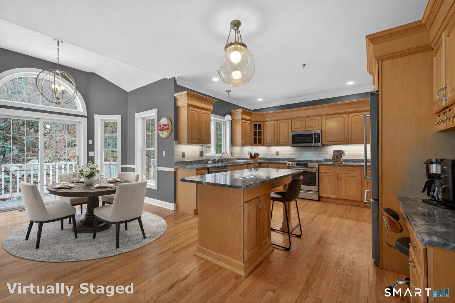 29 Boulder Ridge Southington, CT 06489 - Photo 9 of 40 a open kitchen with stainless steel appliances granite countertop a stove a refrigerator a kitchen island a dining table and chairs with wooden floor