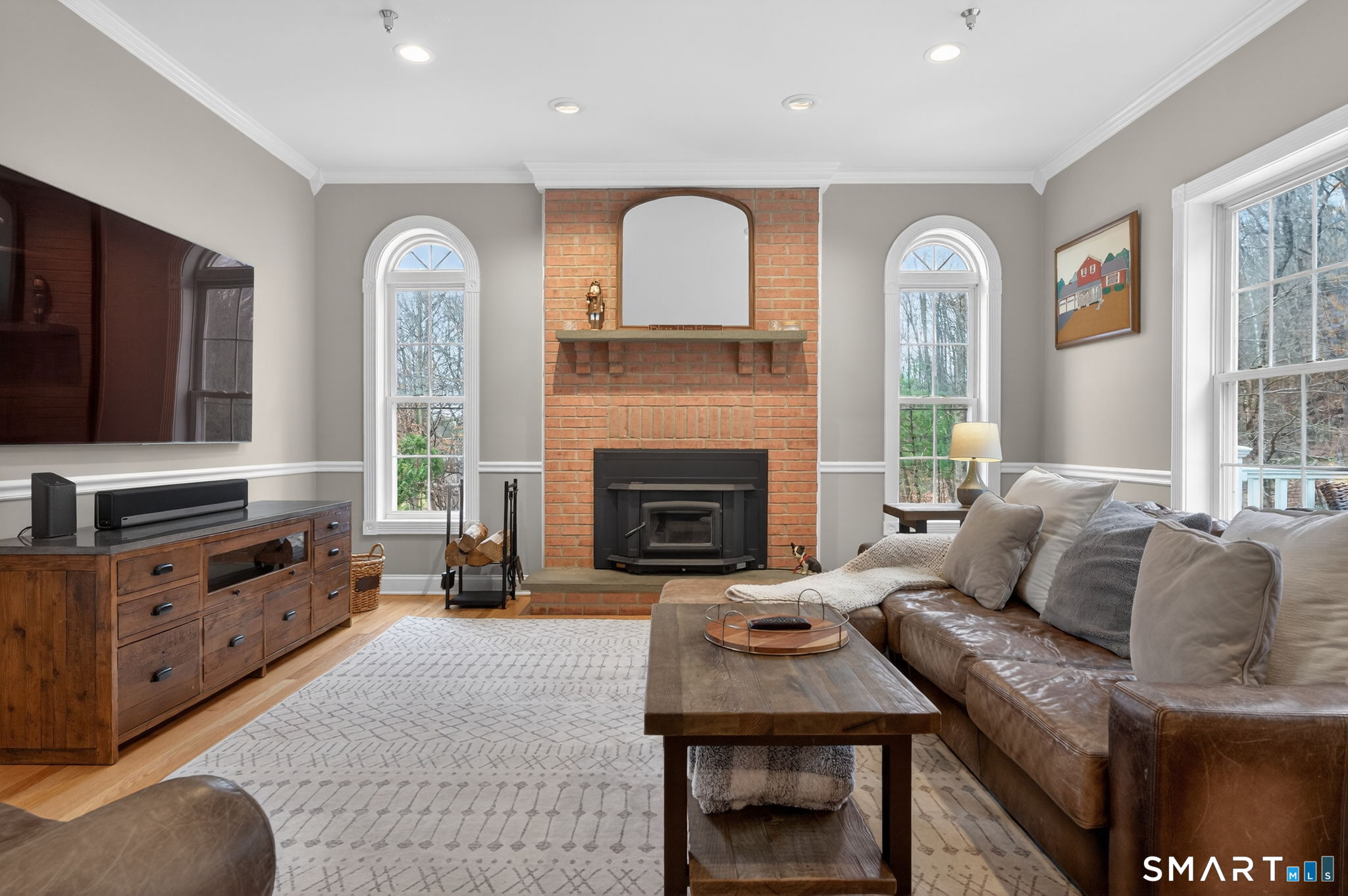 29 Boulder Ridge Southington, CT 06489 - Photo 10 of 40 a living room with furniture a fireplace and a flat screen tv