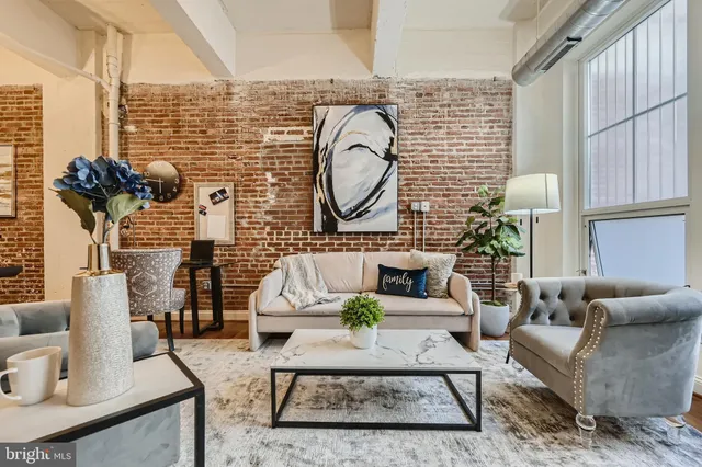 a bedroom with furniture and a large window