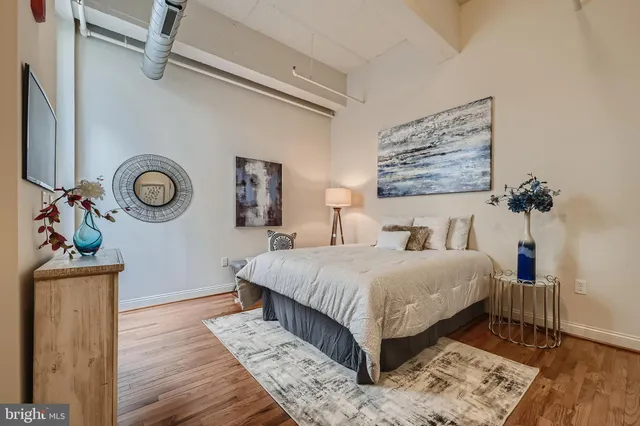 a bedroom with a bed lamp and a dresser