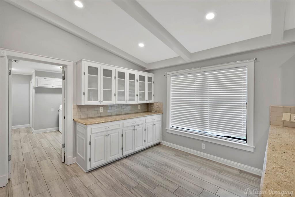 8344 Odom Road Greenwood, LA 71033 - Photo 11 of 39 Kitchen featuring tasteful backsplash, white cabinetry, light wood-style flooring, glass insert cabinets, and recessed lighting