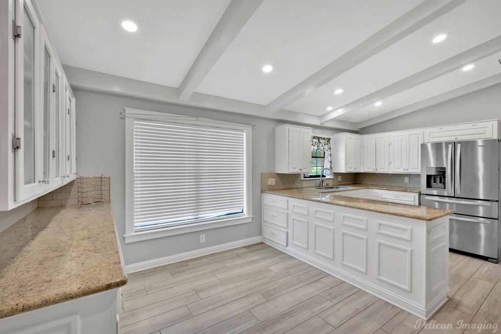 8344 Odom Road Greenwood, LA 71033 - Photo 12 of 39 Kitchen featuring stainless steel fridge, light stone counters, white cabinets, decorative backsplash, and recessed lighting