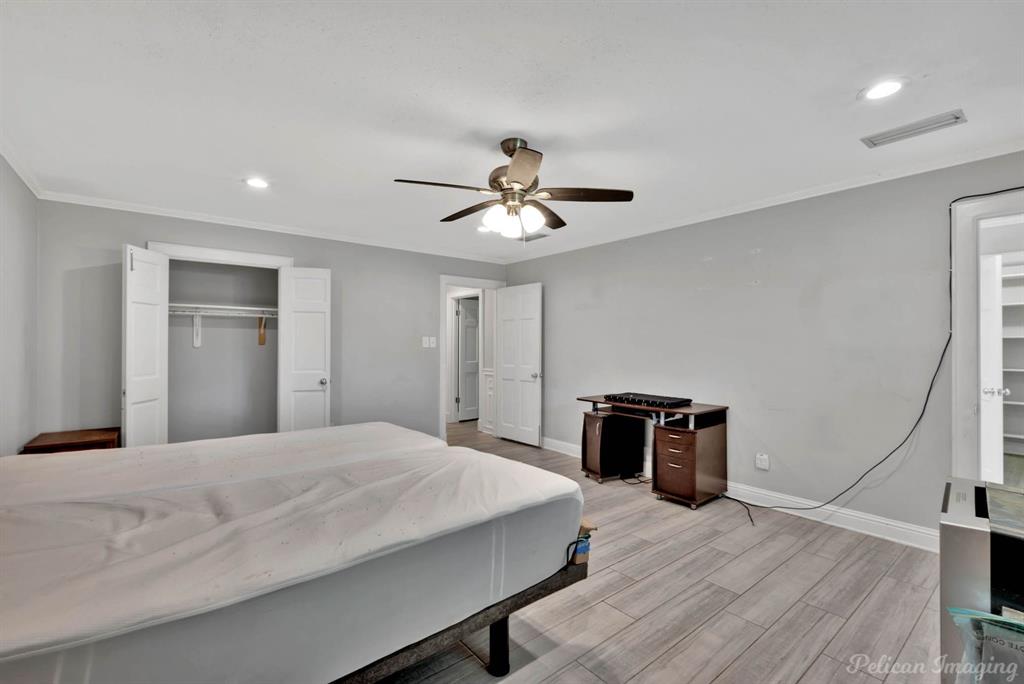 8344 Odom Road Greenwood, LA 71033 - Photo 15 of 39 Bedroom with light wood-style floors, recessed lighting, a closet, ceiling fan, and crown molding