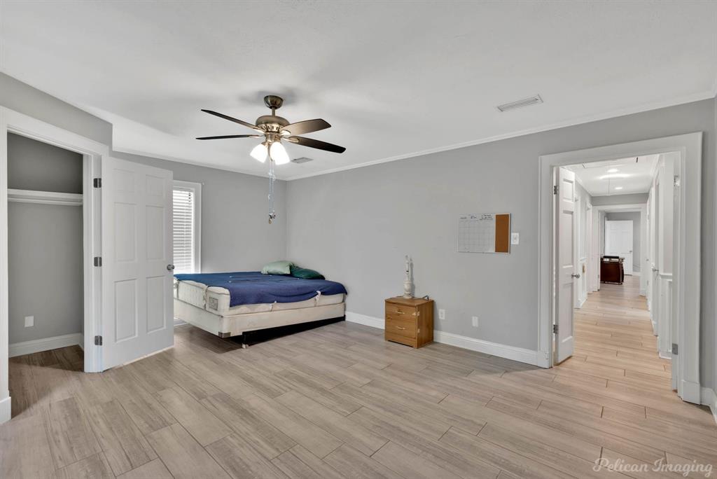 8344 Odom Road Greenwood, LA 71033 - Photo 16 of 39 Bedroom with light wood finished floors, a ceiling fan, and crown molding