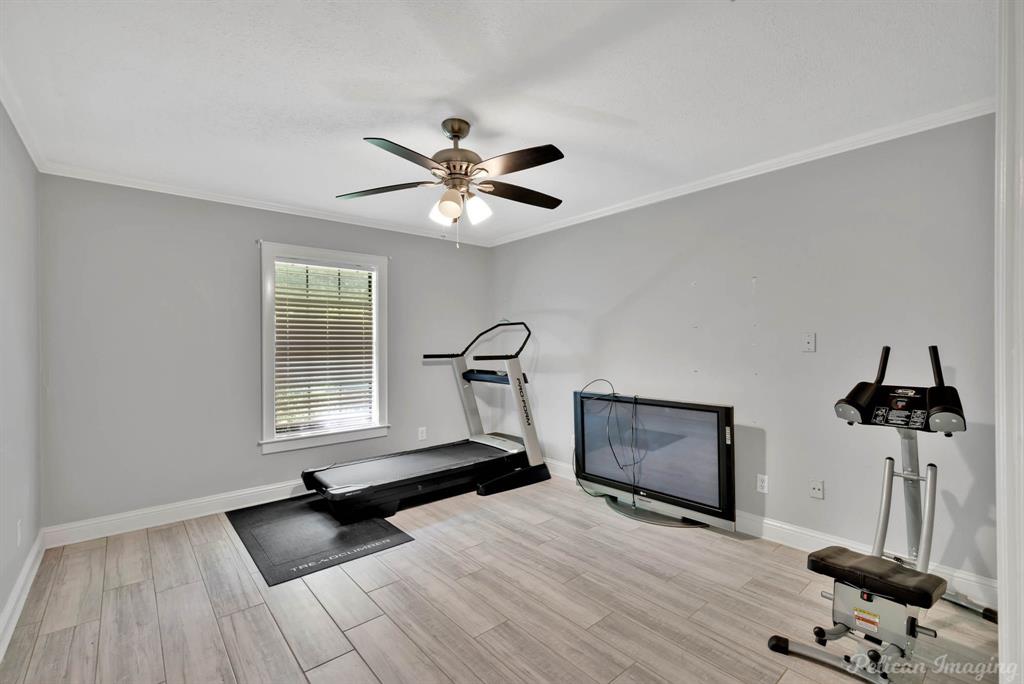 8344 Odom Road Greenwood, LA 71033 - Photo 20 of 39 Exercise room with ornamental molding, a ceiling fan, and wood finished floors