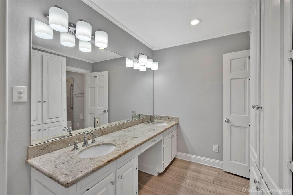8344 Odom Road Greenwood, LA 71033 - Photo 21 of 39 Full bath with double vanity, wood finished floors, crown molding, and recessed lighting