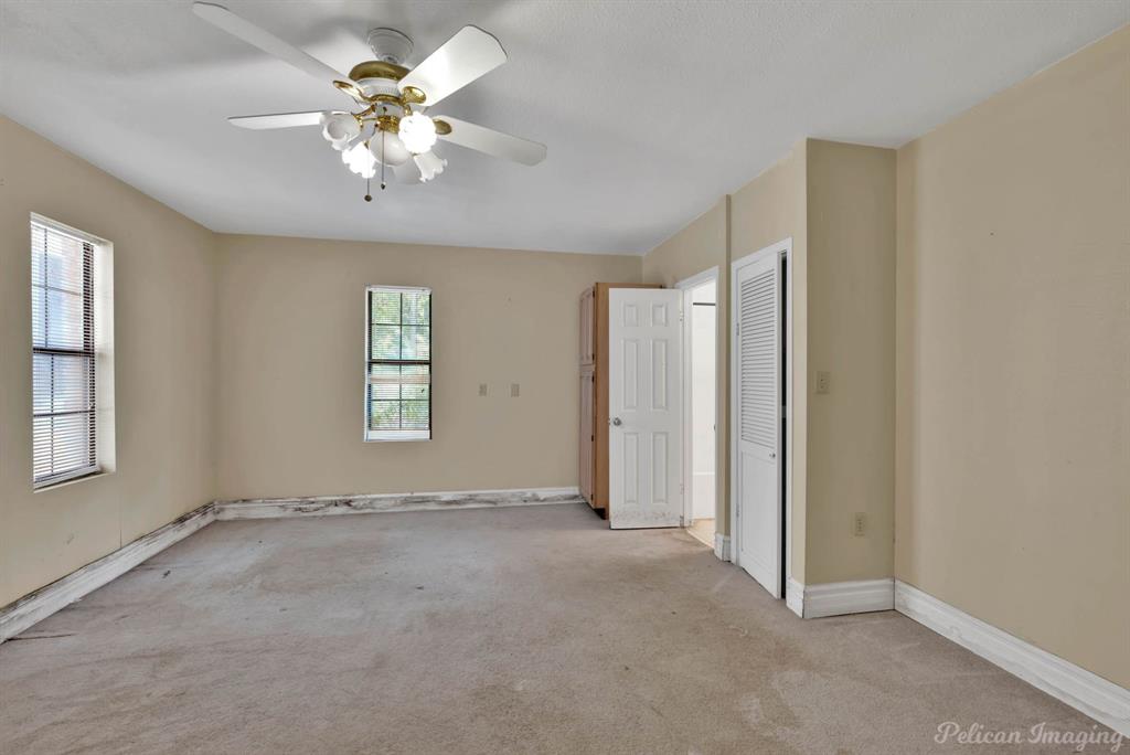 8344 Odom Road Greenwood, LA 71033 - Photo 33 of 39 Guest house - Unfurnished bedroom with carpet, a closet, and a ceiling fan