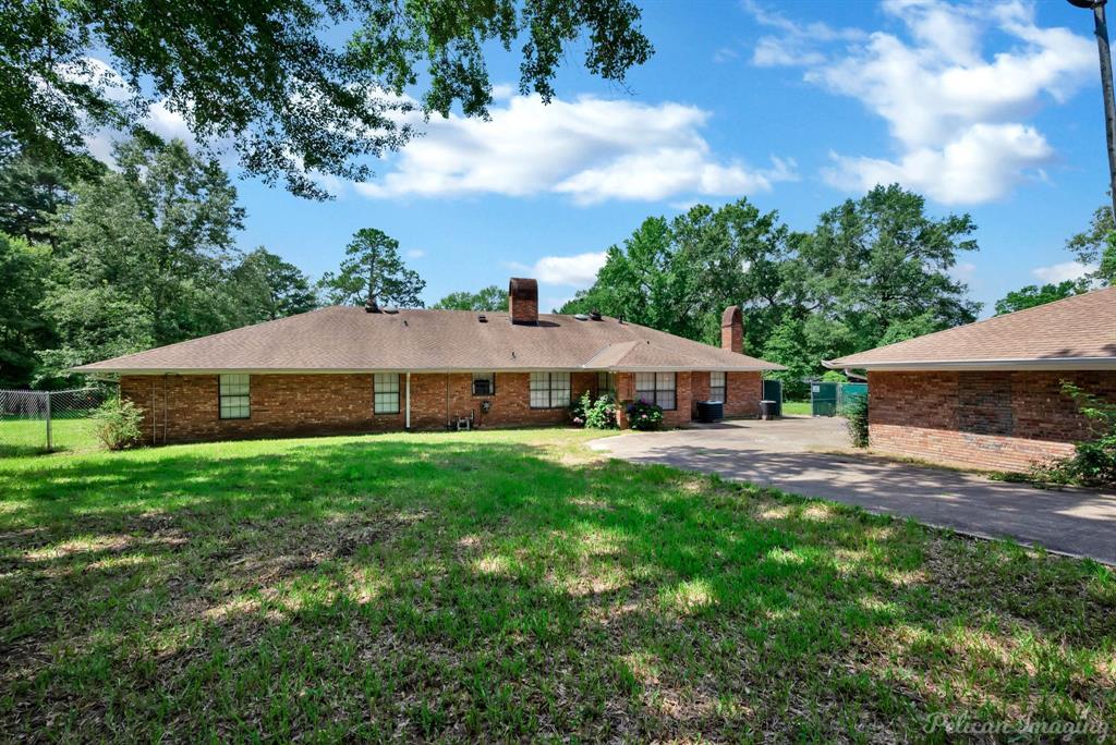 8344 Odom Road Greenwood, LA 71033 - Photo 37 of 39 Back of property with a chimney and brick siding