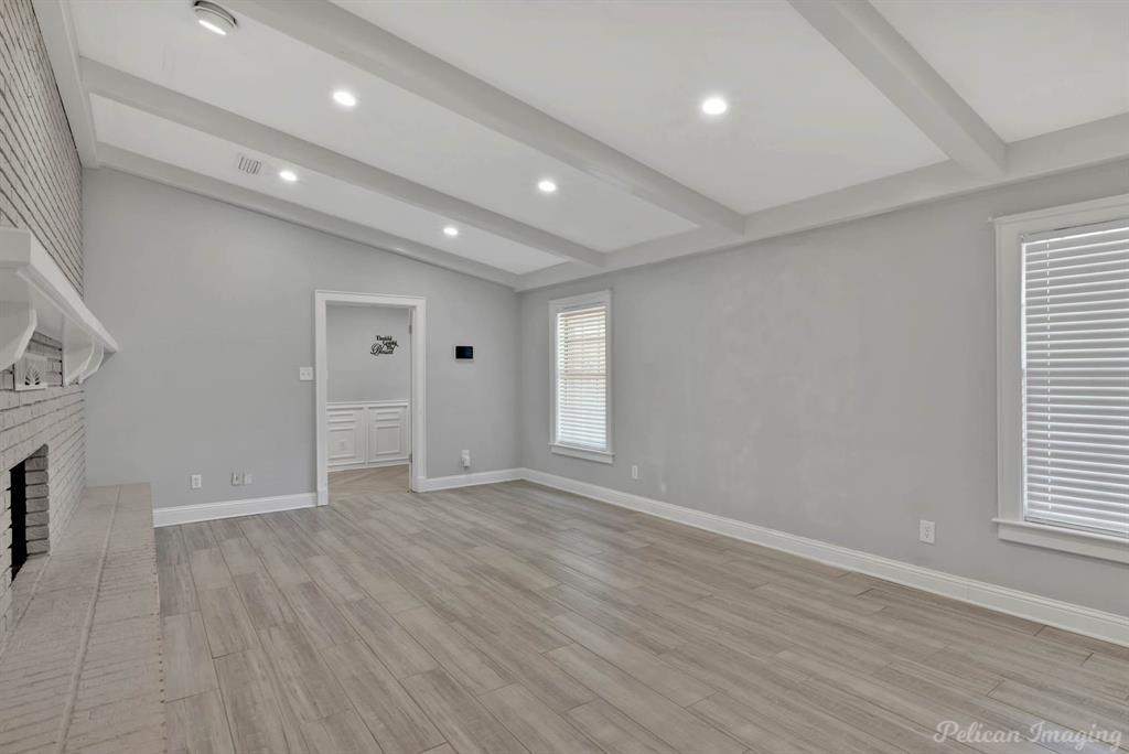 8344 Odom Road Greenwood, LA 71033 - Photo 6 of 39 Unfurnished living room featuring light wood-style floors, a brick fireplace, and recessed lighting