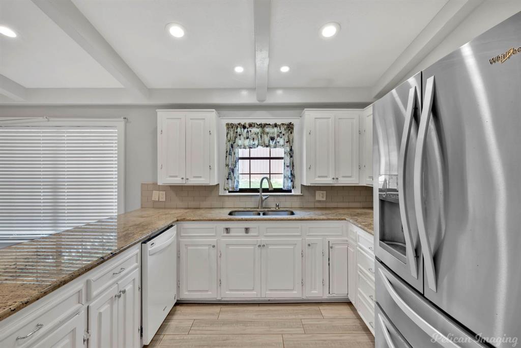 8344 Odom Road Greenwood, LA 71033 - Photo 7 of 39 Kitchen featuring stainless steel refrigerator with ice dispenser, dishwasher, white cabinetry, tasteful backsplash, and recessed lighting