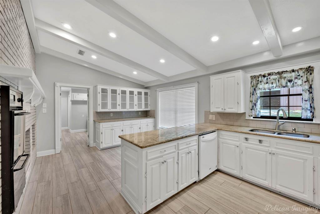 8344 Odom Road Greenwood, LA 71033 - Photo 8 of 39 Kitchen with dishwasher, decorative backsplash, light stone counters, light wood finished floors, and recessed lighting