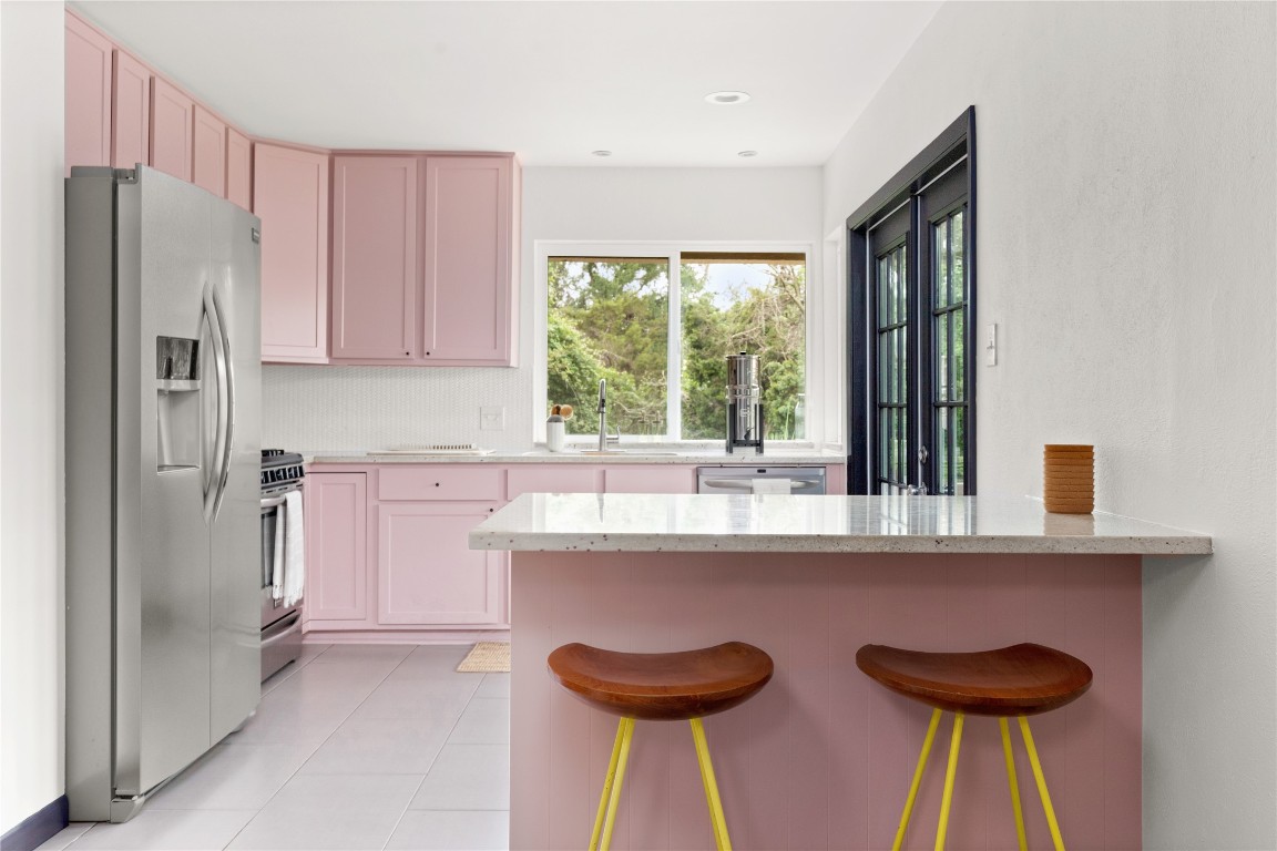 705 Battle Bend Boulevard Austin, TX 78745 - Photo 1 of 27 a kitchen with stainless steel appliances granite countertop a sink a stove and a refrigerator