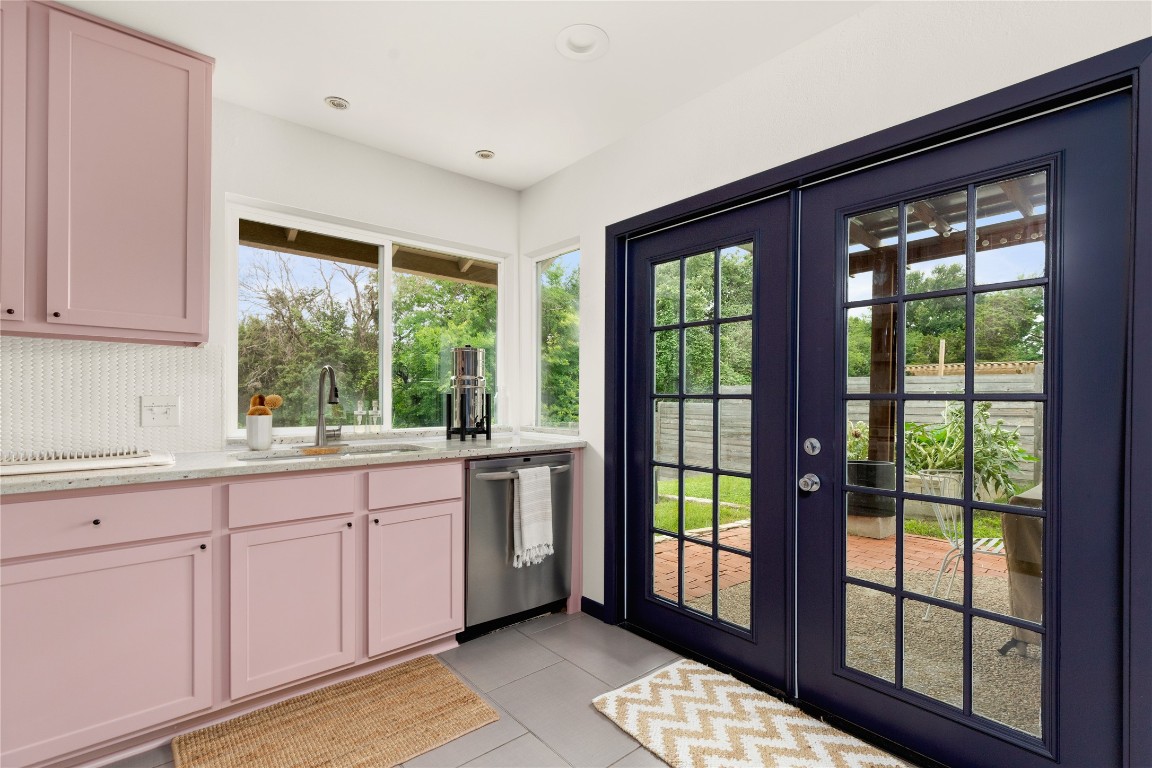 705 Battle Bend Boulevard Austin, TX 78745 - Photo 11 of 27 a kitchen with granite countertop a stove a sink and white cabinets