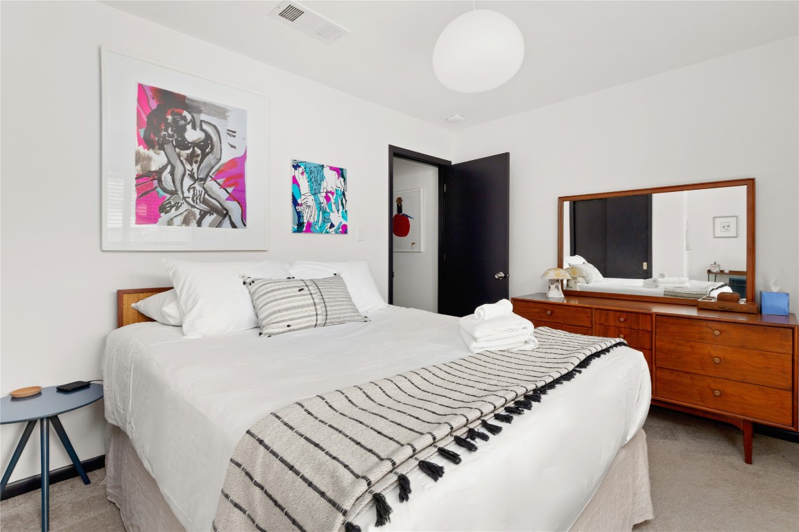 705 Battle Bend Boulevard Austin, TX 78745 - Photo 14 of 27 a bedroom with a bed and a large mirror on the dresser