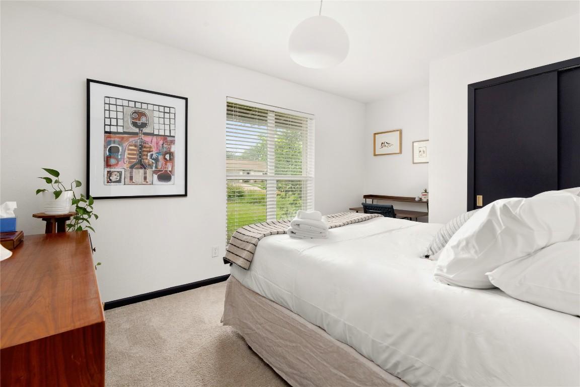 705 Battle Bend Boulevard Austin, TX 78745 - Photo 15 of 27 a bedroom with a large bed and a window