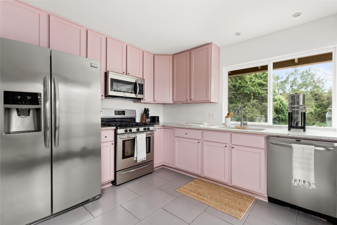 705 Battle Bend Boulevard Austin, TX 78745 - Photo 10 of 27 a kitchen with granite countertop a stainless steel appliances and counter space