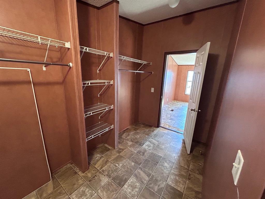 329 Canvas Back Drive Princeton, LA 71067 - Photo 13 of 20 Walk in closet with stone finish flooring Master