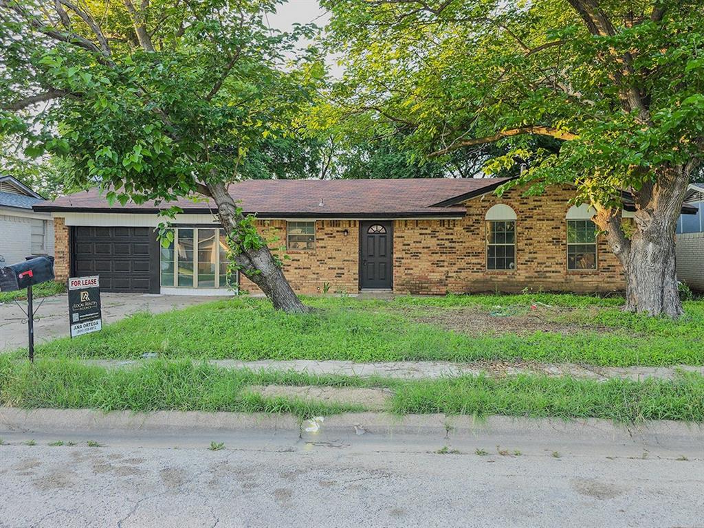 a front view of a house with a garden and yard