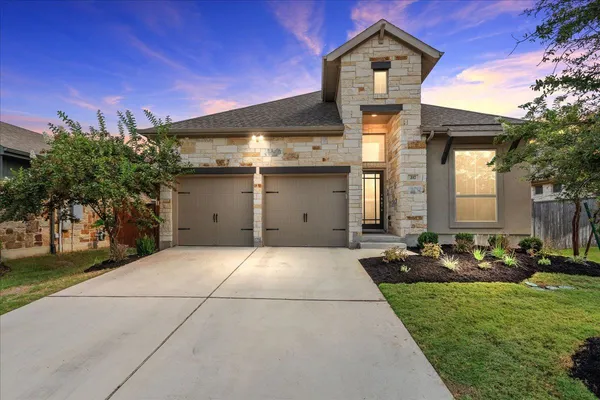 a front view of a house with garden