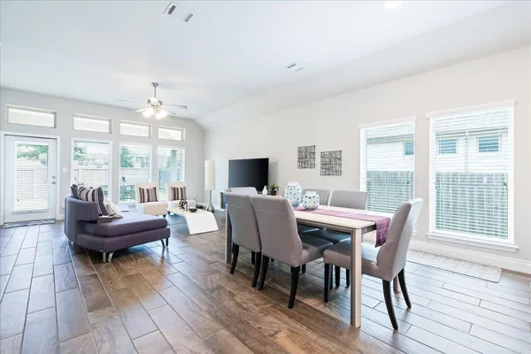 a view of a dining room with furniture and wooden floor