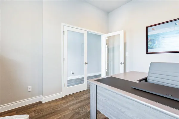 a view of a bedroom with wooden floor