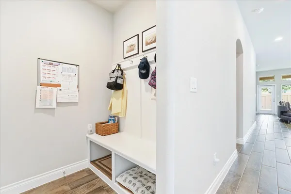 a hallway with painting on the wall and a table