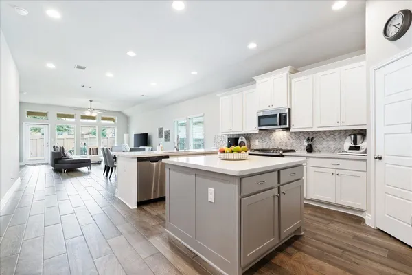 a kitchen with a sink appliances and cabinets