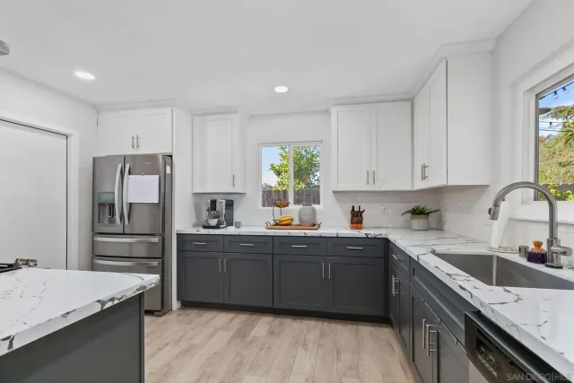 a kitchen with a sink a stove a refrigerator and cabinets