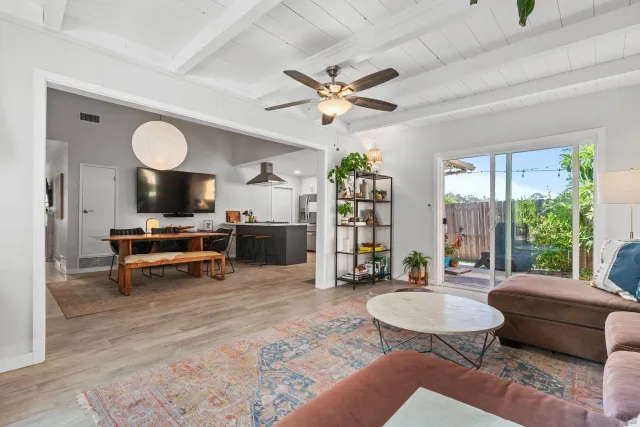 a living room with furniture a rug and a large window