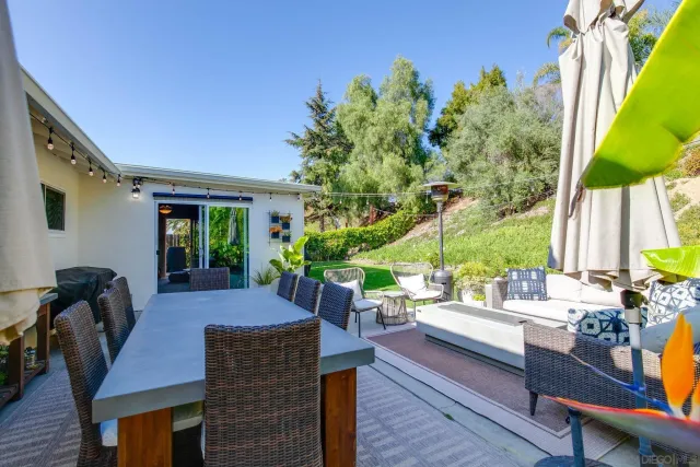 a view of a patio with table and chairs potted plants with wooden floor