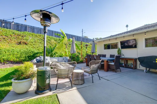 a living room with patio furniture and a potted plants