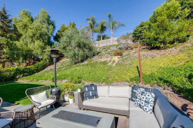 a view of a patio with couches table and chairs and potted plants