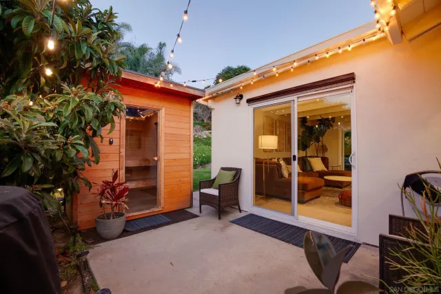 a backyard of a house with barbeque oven table and chairs