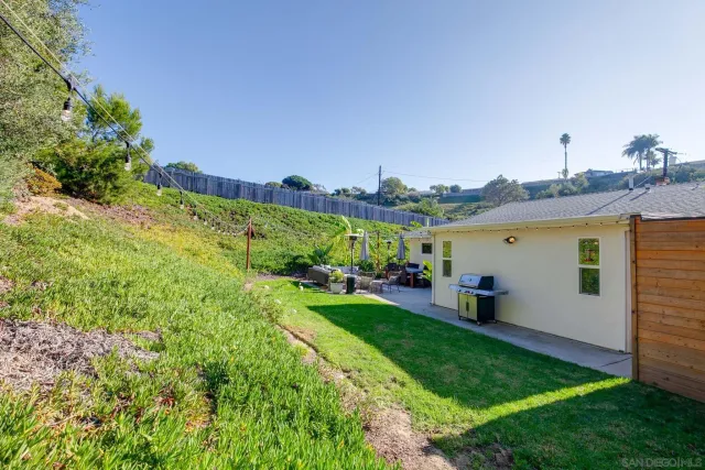 a view of a backyard with plants and a patio
