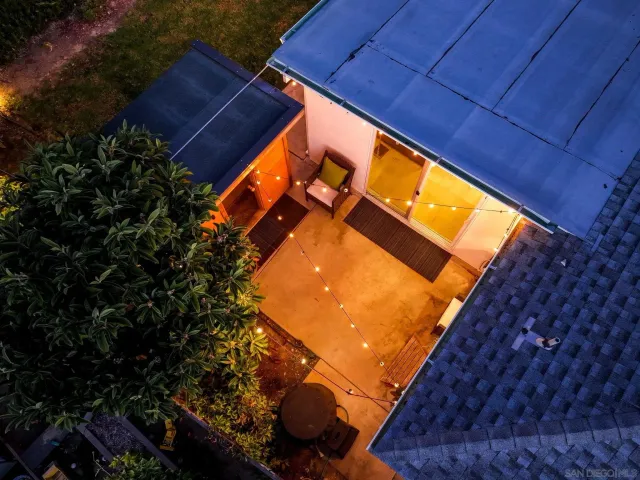 a view of a patio with table and chairs under an umbrella