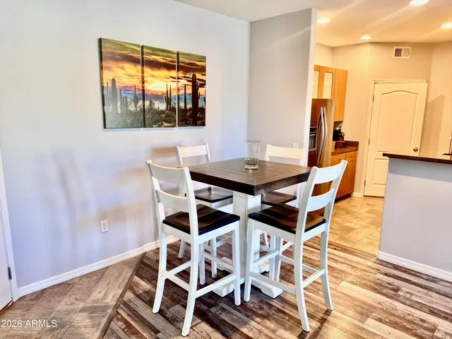 a kitchen with sink a refrigerator and wooden floor