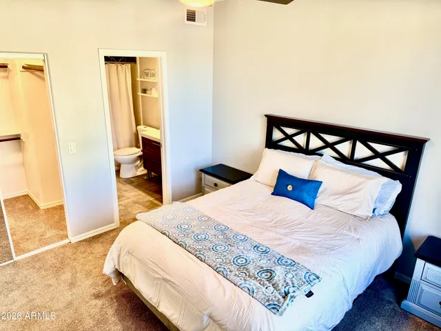 a bedroom with a bed and a dresser