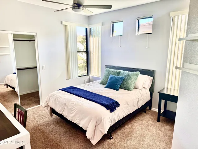 a bedroom with a bed and a table in it