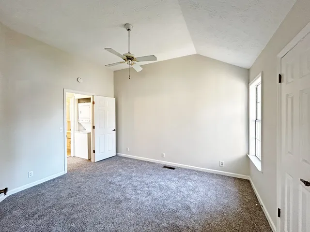 an empty room with a empty space and a ceiling fan