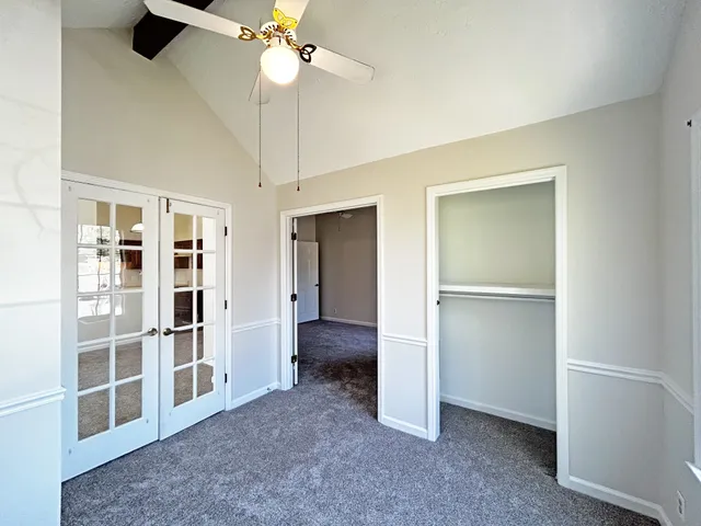 a view of empty room with a ceiling fan and a window