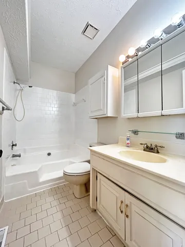 a bathroom with a sink a toilet and bathtub