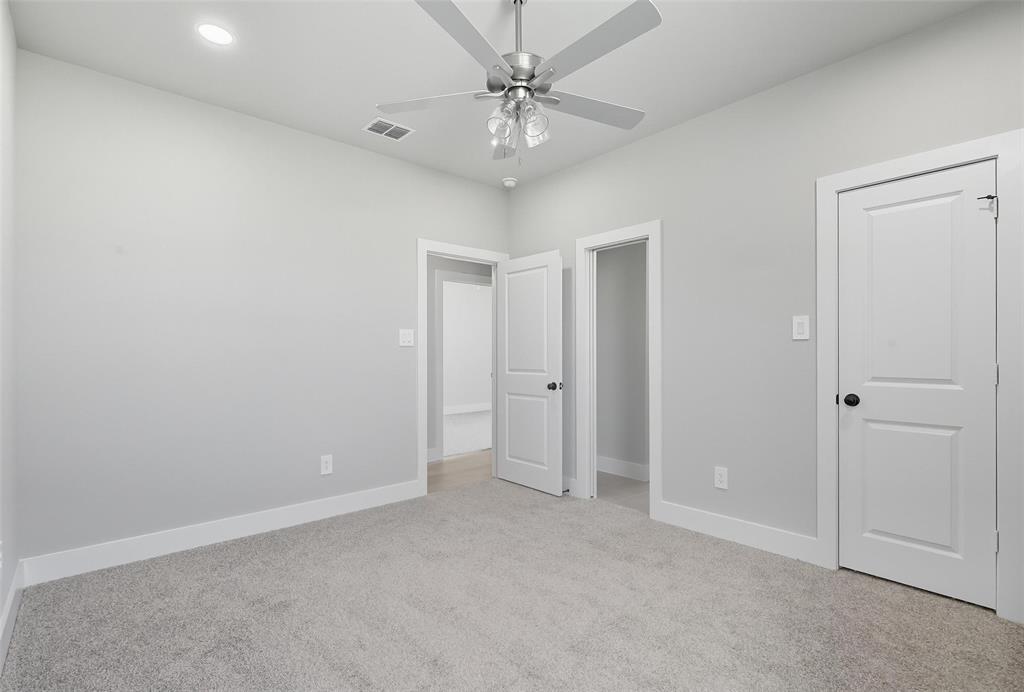1005 Ronnie Court Springtown, TX 76082 - Photo 24 of 27 Unfurnished bedroom featuring light colored carpet, a ceiling fan, and recessed lighting