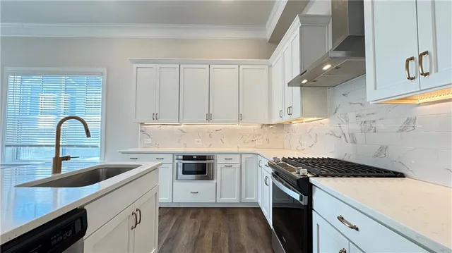 a kitchen with a sink cabinets and stainless steel appliances