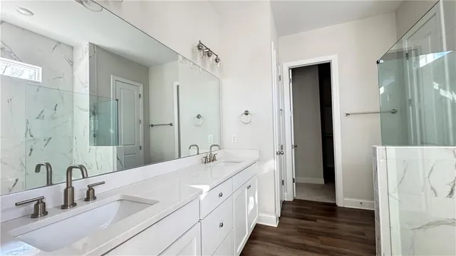 a spacious bathroom with double vanity and mirrors