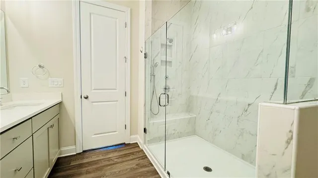 a bathroom with a shower and a sink