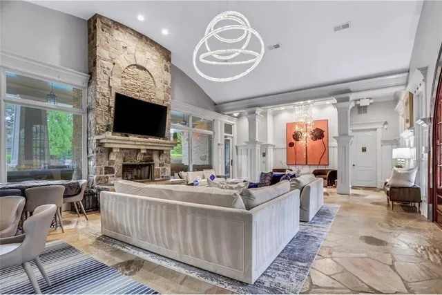 a living room with fireplace furniture and a flat screen tv